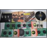 The Beatles A collection of vinyl long play LP records together with a selection of 7" 45rpm vinyl