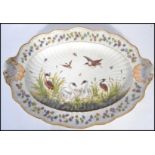 A 19th century ceramic platter meat tray depicting swans and cranes with insects. Floral sprays with