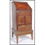A late 19th century / early 20th century fall front mahogany drop well  bureau of small proportions,