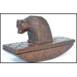 A 19th century Blackforest carved blotter in the form of a bear with shaped blotter base. Measures