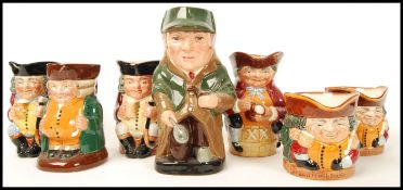 A group of seven Royal Doulton character Toby Jugs to include The Squire , Jolly Toby x2 , The