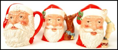 A group of three Royal Doulton Character jugs to include Santa Claus D6675 with reindeer handle ,