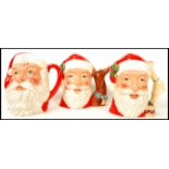 A group of three Royal Doulton Character jugs to include Santa Claus D6675 with reindeer handle ,