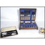 A vintage early 20th century oak cased canteen of silver plated six setting cutlery together with