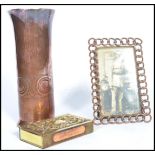 A group of three vintage 20th century Trench Art brass items to include a picture frame with a