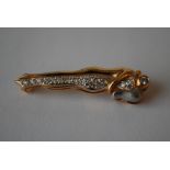 An 18ct gold and diamond figural brooch in the form of an intertwined couple. Marked 18k 750 tests