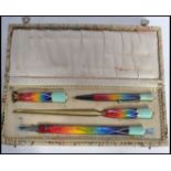 A stunning 20th century Art Deco writing set to include pencil, seal, paper knife and pen, in fitted