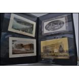 A large album of assorted early 20th Century postcards - including real photo, street scenes, some