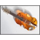 A vintage sterling silver and amber brooch in the form of a violin with pin to verso.