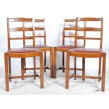 A set of 4 1930's Art Deco oak rail back dining chairs being raised on squared legs united by