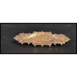 A vintage early 20th century Edwardian hallmarked 9ct gold bar brooch decorated with flowers