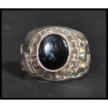 An unusual silver hallmarked oversized American Superbowl football ring having a central onyx