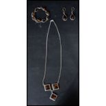 A sterling silver and amber demi-parure set consisting of necklace bracelets and earrings. Total