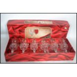 A boxed cased set of cut glass lead crystal wine glasses together with a lead glass decanter with