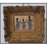 A 19th century Victorian silhouette cut out pictures depicting a group of three children playing
