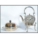 A late 19th century Victorian silver plated rococo spirit burner teapot, raised on stand with