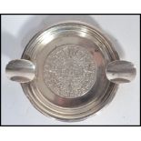 A silver ashtray of circular form, central Mayan d
