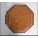 A Robert Thompson of Kilburn  ' Mouseman ' octagonal cheese board with trademark mouse on the