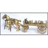 An early 20th century heavy cast brass figurine group of a horse and cart with miniature brass