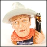 A Royal Doulton large character jug limited edition John Wayne D7269. Measures 18cms high. Note;