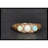 A hallmarked 9ct gold three stone opal dress ring.