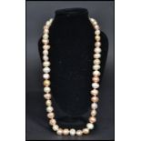 vintage freshwater pearl necklace strand. The pearls of varying form but similar size.