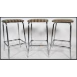 A set of 3 mid century chrome bar stools. Each with tubular chrome tall frames complete with the