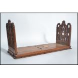 A 19th century mahogany ecclesiastical extending book stand trough on plinth  base with pierced