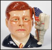 A Royal Doulton character jug depicting President John F Kennedy D7246, handle modelled as the the