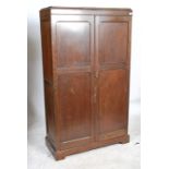 A 1930's oak Aw-Lyn double wardrobe compactum having oak full length qtr panel doors with