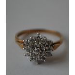 A hallmarked 9ct gold cluster ring being set with round cut CZ.  Hallmarked London. Size O. Weight