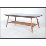 A vintage retro 20th century Ercol gold label low coffee table having a rail bottom raised on