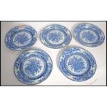 A set of five early 19th century pearlware pearl ware blue and white cabinet plates depicting