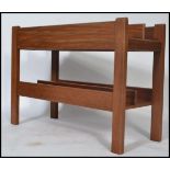 A 1970's Danish teak wood retro magazine rack - canterbury by Guy Rogers. The panelled body with