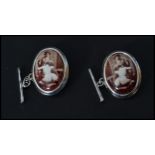 A pair of sterling silver and enamel cuff links depicting a nude erotic scene. Weighs 9 grams.