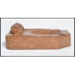 A Robert ' Mouseman ' Thompson oak ashtray of rectangular form with canted corners and with