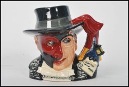 A Royal Doulton character jug depicting The Phantom of the Opera D7017 , handle modelled after a