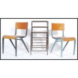 A retro 1960's pair of French industrial stacking chairs having plywood seats and backrests along