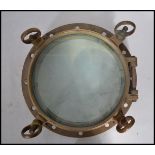 A good early 20th century heavy cast brass ships porthole of circular form. Measures 39cm.