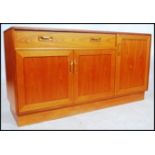 A 1970's retro teak wood sideboard by Ernest Gomme / G-Plan. In the Kelso pattern being raised on