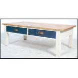 A 20th century shabby chic coffee table. Of rectangular form with drawers to the frieze having