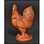 An Oriental Japanese netsuke carved in the form of a cockerel. Signed to base.
