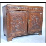 A 19th century country oak cupboard two full length doors swag drop brass handles raised on