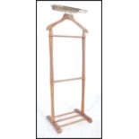 A vintage mid century light beech wood gentleman's valet stand having railed top and stretchers to