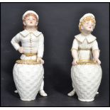 A 19th century Victorian pair of Royal Worcester blush ivory Kate Greenaway figures, modelled as a