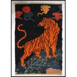 An early 20th century Tibetan tiger rug.  The blue ground with large central tiger  chasing swirling