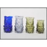 A group of four Whirefriars studio art coloured pressed glass Toby Jugs in green blue and smokey