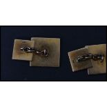 A pair of vintage early 20th century 14 carat gold cufflinks / cuffs of square form having an engine