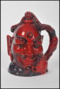 A Royal Doulton flambė character jug depicting Aladdin's Genie D6971 , handle modelled on a genie'