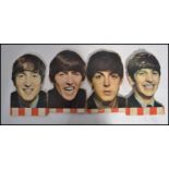 The Beatles - A set of four cut outs and mounted on wood possible shop advertising pieces of The